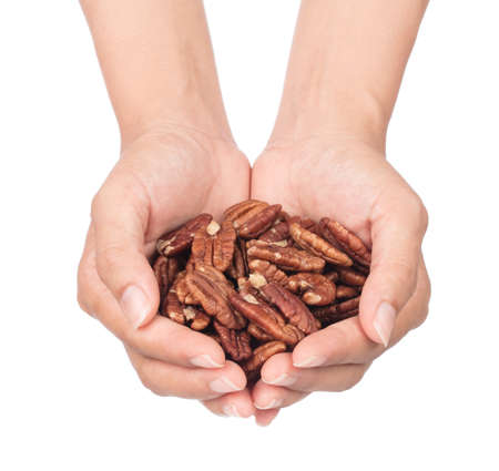 hand holding Pecan nuts isolated on white backgroundの写真素材