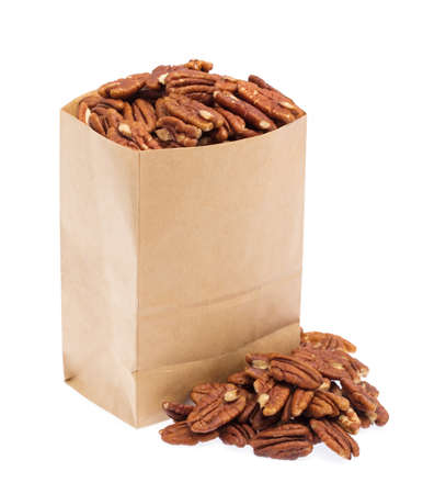 pecan nuts in paper bag isolated on white background