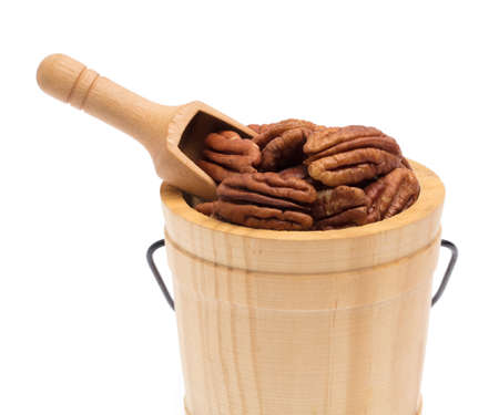 Pecan nut in small wooden bucket isolated on white background