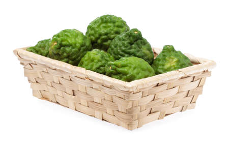 Bergamot fruit in bamboo basket isolated on white backgroundの写真素材