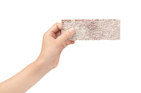 hand holding white chocolate with chocolate chip bars isolated on a white background.