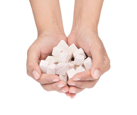 hand holding cube of taro isolated on white backgroundの写真素材