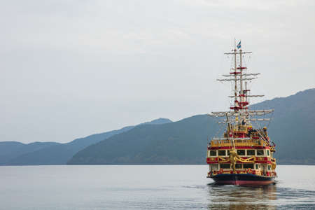 Tokyo, JAPAN - October 21, 2016:Pirate cruise ship (kaizokusen) over Hakone's lake Ashi landscape.のeditorial素材