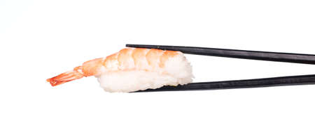 holding sushi shrimp by chopsticks isolated on white backgroundの写真素材
