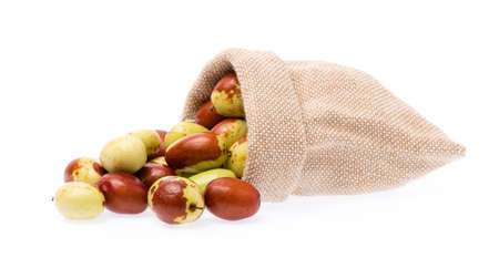 Textile-burlap sack of chinese jujube isolated on white backgroundの写真素材