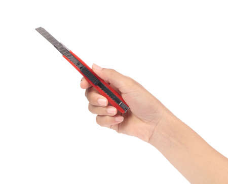 hand holding Red cutter knife isolated on white background
