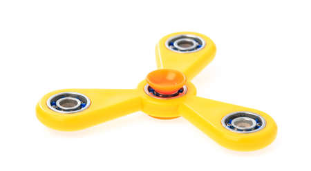 Yellow Fidget Spinner isolated on a white backgroundの写真素材