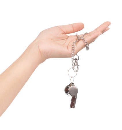 hand holding metal whistle isolated on white backgroundの写真素材