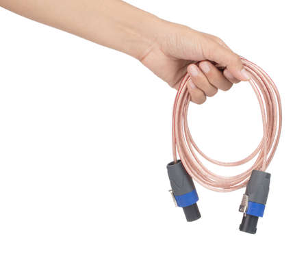 Hand holding Plug speakon with speaker cable isolated on white background.の写真素材