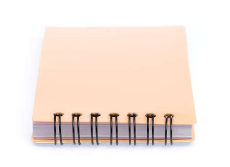 orange note book isolated on a white backgroundの写真素材