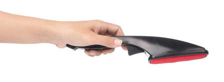 hand holding a black brush coarse for cleaning clothes from dust isolated on white background