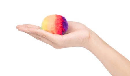 colorful of Fur ball on hand isolated on white backgroundの写真素材