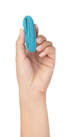hand holding green wool yarn isolated on white background
