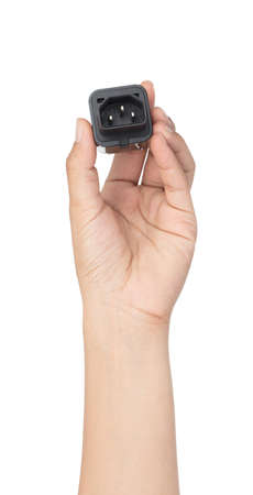 Hand holding UK 3-Pin Plug Adapter isolated on white backgroundの写真素材