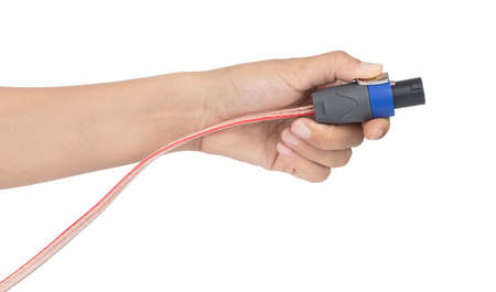 Hand holding Plug speakon with speaker cable isolated on white background.の写真素材