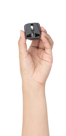 Hand holding UK 3-Pin Plug Adapter isolated on white background