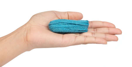 hand holding green wool yarn isolated on white background