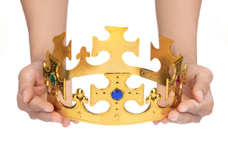 Hand holding crown golden isolated on a white background