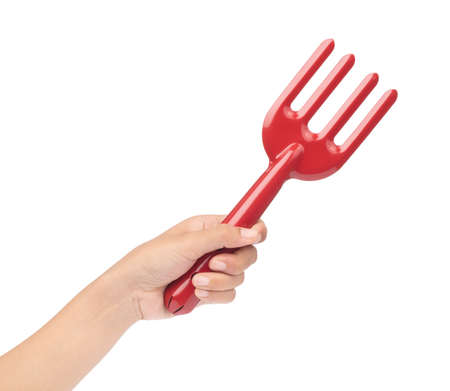 hand holding Red Garden rake isolated on white background