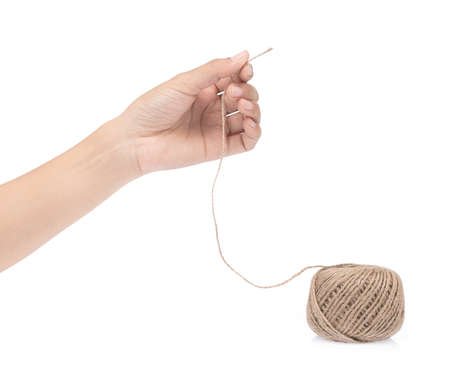 hand holding wool yarn isolated on a white background.の写真素材