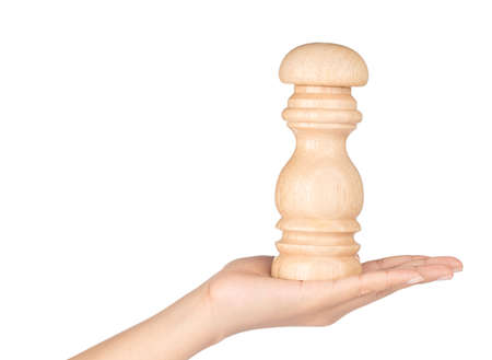 hand holding wood bottle mashed for pepper isolated on white backgroundの写真素材