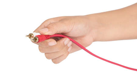 Hand holding Plug RCA Audio jack cable isolated on white background