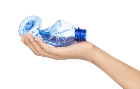 Hand holding smashed empty plastic bottle isolated on a white background
