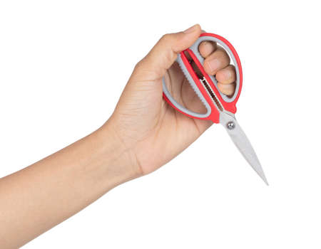 Hand holding red scissors isolated on white background.の写真素材