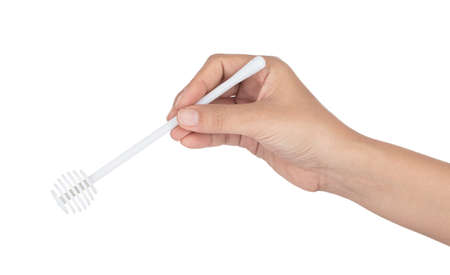 hand holding honey dipper isolated on white background