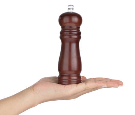 Hand holding Pepper mill isolated on white backgroundの写真素材