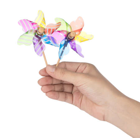 Hand holding two colorful pinwheel isolated on white background