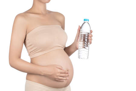 Young pregnant woman holding a water bottleの写真素材