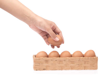hand holding eggs in basket isolated on white backgroundの写真素材