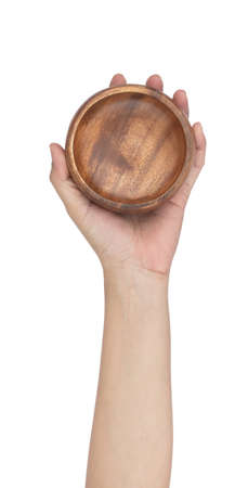 Hand holding Wooden bowl isolated on a white backgroundの写真素材