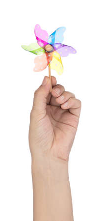 Hand holding colorful pinwheel isolated on white backgroundの写真素材