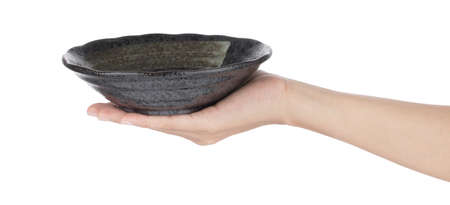 Hand holding Stone ware Bowl Isolated on white backgroundの写真素材