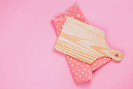 Paddle cutting Board on pink backgroundの写真素材