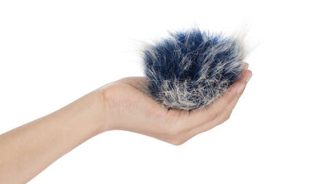 Hand holding Blue fur ball isolated on white background