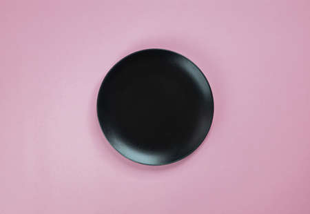 Black dish on a pink backgroundの写真素材