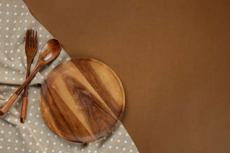 Wooden Kitchenware set with brown tablecloth on brown backgroundの写真素材