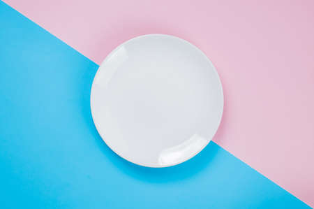 White dish on a pink and blue backgroundの写真素材