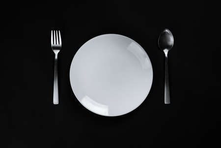 A white plate on black backgroundの写真素材