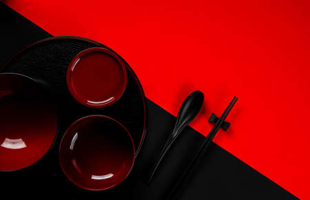 Kitchenware bowl set on black and red backgroundの写真素材