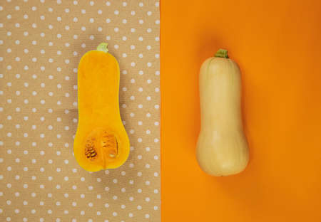Butternut squash with tablecloth on orange backgroundの写真素材