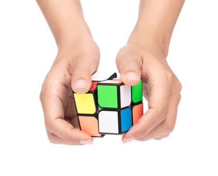 Thailand, Ubon Ratchathani. October 19, 2017. Hand holding Rubik's cube isolated on a white background.  Rubik's Cube invented by a Hungarian architect Erno Rubik in 1974.のeditorial素材