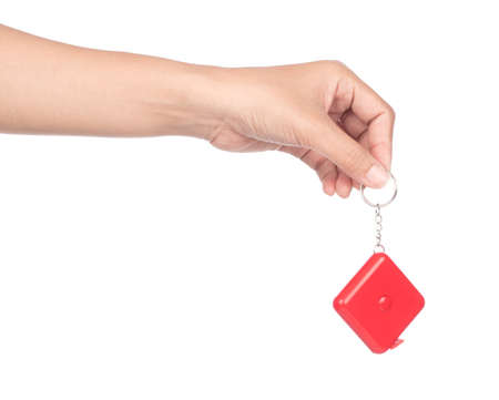 hand holding Measuring tape of the tailor for design isolated on white backgroundの写真素材