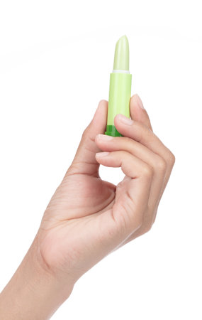 Hand holding lip balm stick isolated on a white background.の写真素材