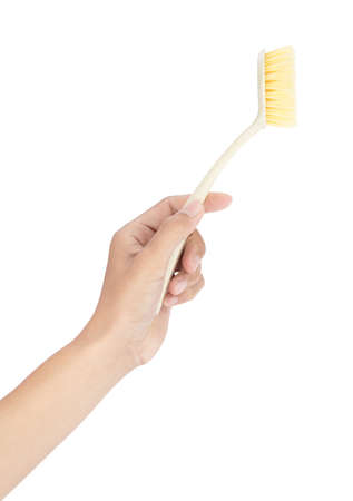 Hand holding House cleaning plastic brush tool isolated on white background.の写真素材