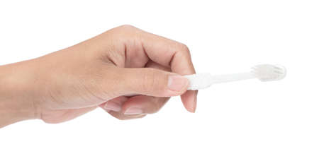 Hand holding Close up of toothbrush isolated on a white backgroundの写真素材