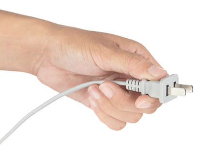 Hand holding Grey Power plug isolated on white background.の写真素材